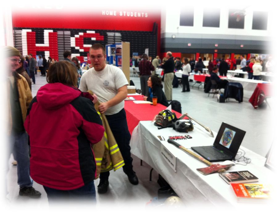 Firefighters speak to participants at a career fair