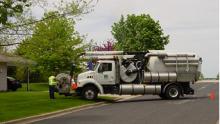 A Vacuum truck working in a city